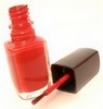 red nail polish and brush