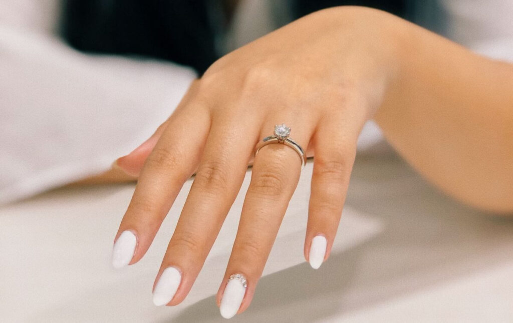 beautiful white polished fingernails