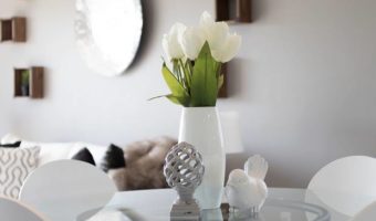 white tulips against white interior wall