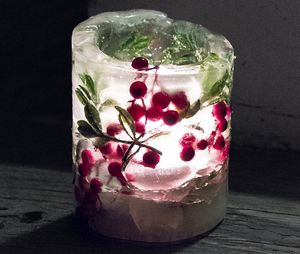 ice candles with faux greenery and berries