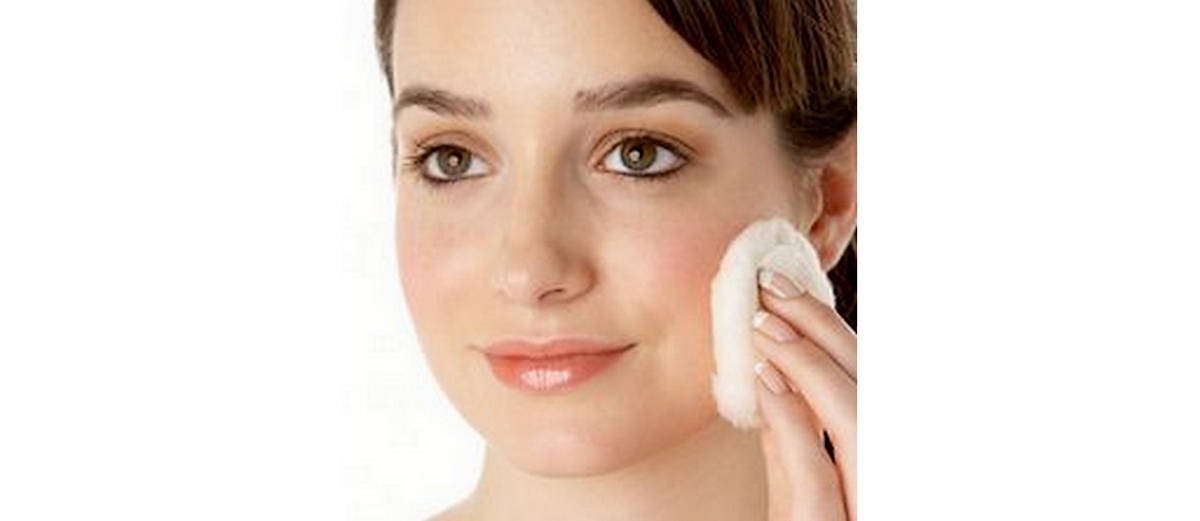 woman applying facial toner