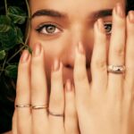 woman holding beautiful nails up to her face